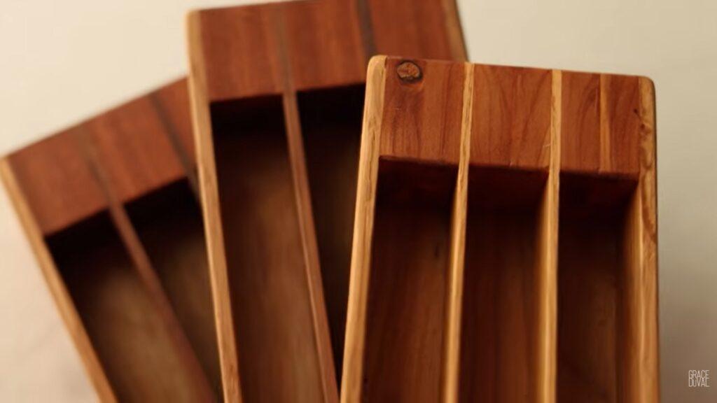 Three wooden boxes made of oak and cedar, stacked on top of each other. They each have three sections allowing crafters to store beads for use while beading. Only half of the boxes are visible in the image.