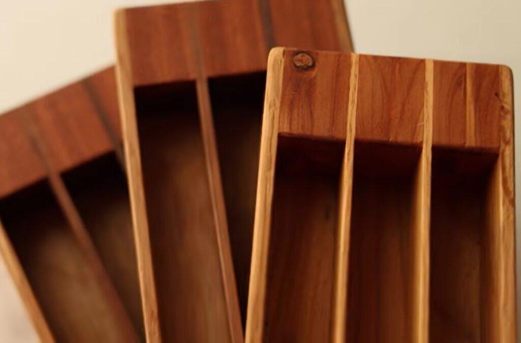 Three wooden boxes made of oak and cedar, stacked on top of each other. They each have three sections allowing crafters to store beads for use while beading. Only half of the boxes are visible in the image.