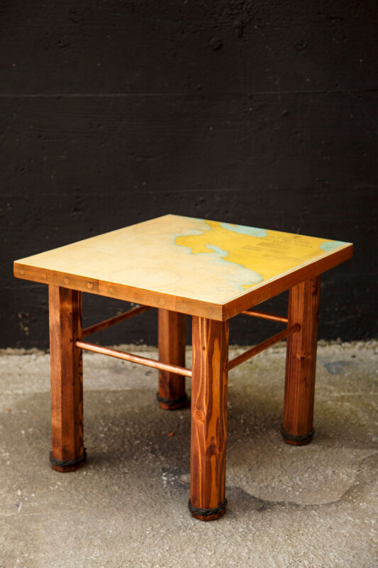 side table made from construction scraps, featuring a used nautical chart