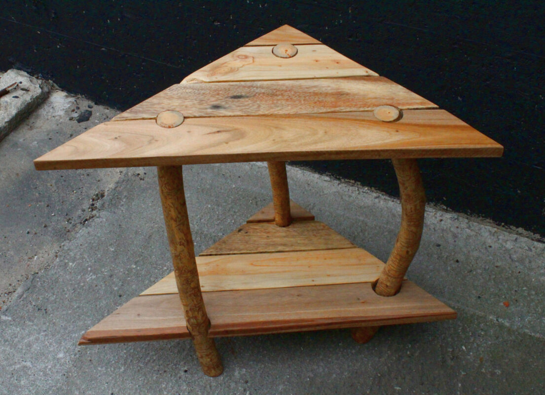 corner table made from pallets and worm-etched branches